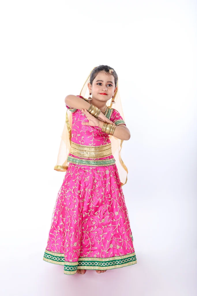 A Cute Little Girl Wearing Radha Dress Standing while Posing at the Camera  · Free Stock Photo